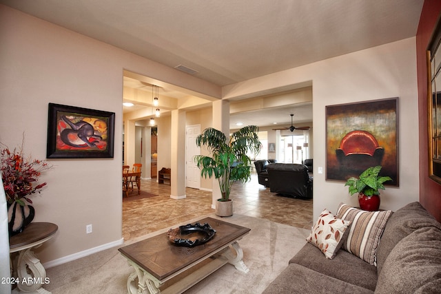 living room featuring light carpet and ceiling fan