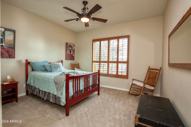 bedroom with ceiling fan and light carpet