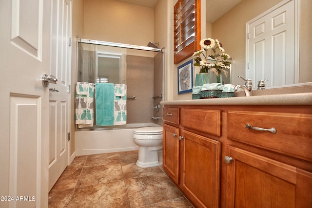 full bathroom with vanity, toilet, tile patterned floors, and shower / bath combination with glass door