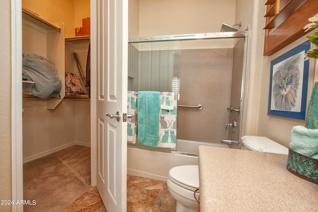 bathroom featuring toilet, tile patterned floors, and shower / bath combination with glass door