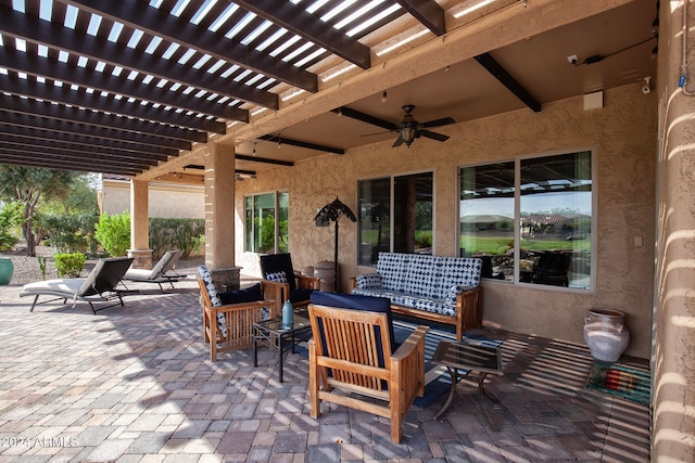 view of patio featuring an outdoor hangout area, ceiling fan, and a pergola