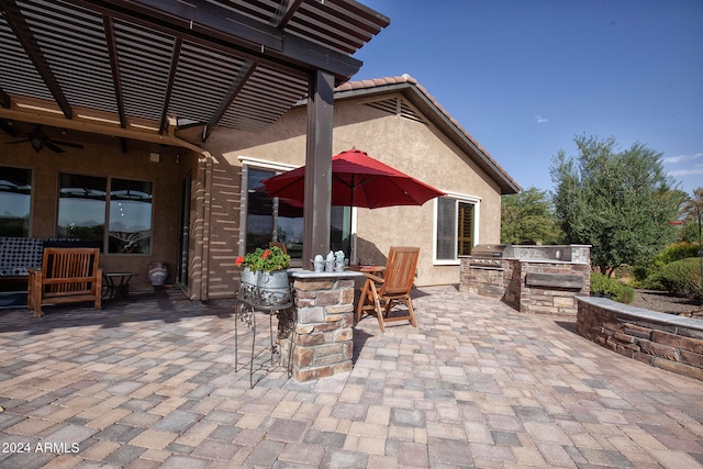 view of patio / terrace with a pergola, exterior kitchen, a grill, and ceiling fan