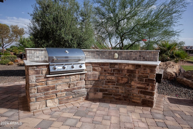 view of patio featuring exterior kitchen and grilling area