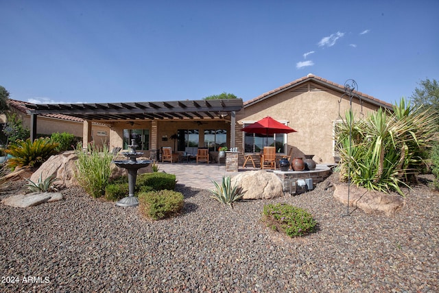 back of property featuring a patio and a pergola