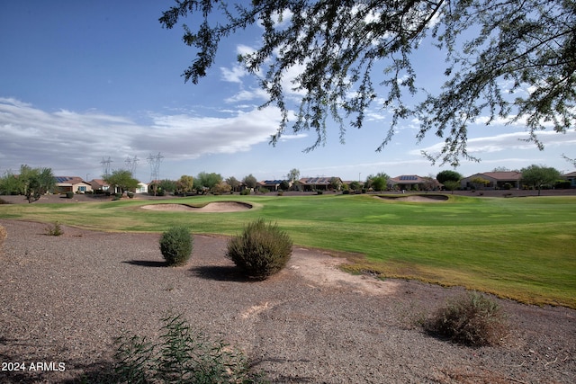 view of property's community with a lawn