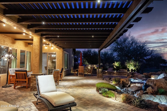 patio terrace at dusk with a pergola