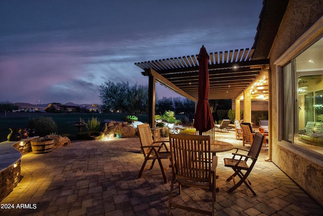 patio terrace at dusk with a pergola