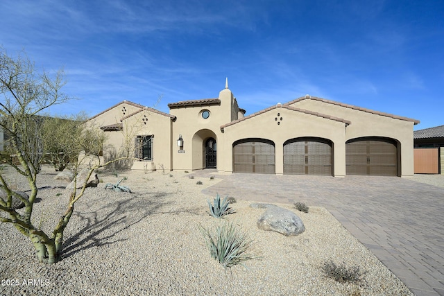 mediterranean / spanish-style home with a garage