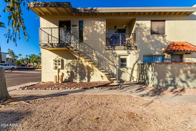 back of property featuring a balcony