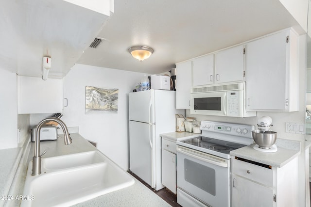 kitchen featuring sink, white cabinetry, and white appliances