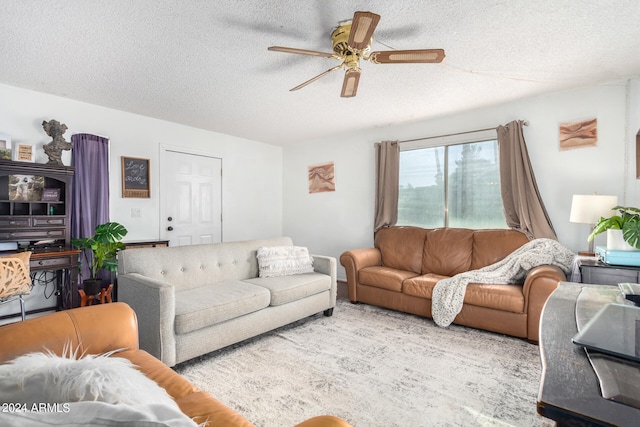 living room with a textured ceiling and ceiling fan