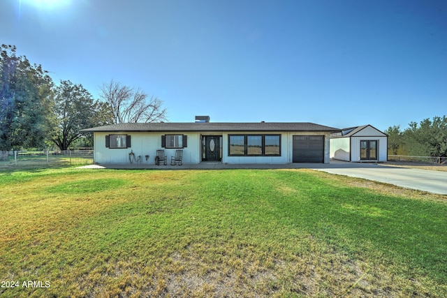 ranch-style home with an outbuilding and a front yard