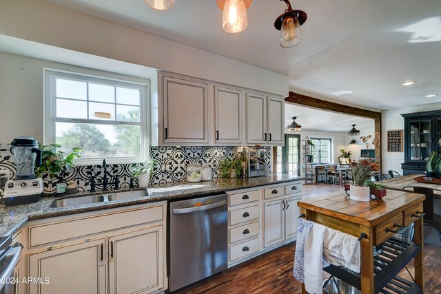 kitchen with dishwasher, sink, dark wood-type flooring, and a healthy amount of sunlight