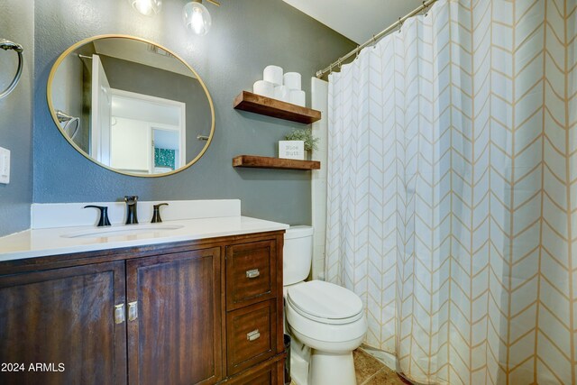 bathroom with a shower with curtain, vanity, and toilet