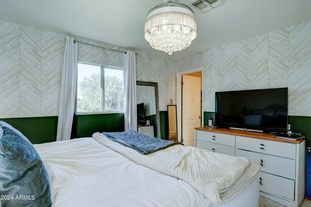 bedroom featuring a notable chandelier