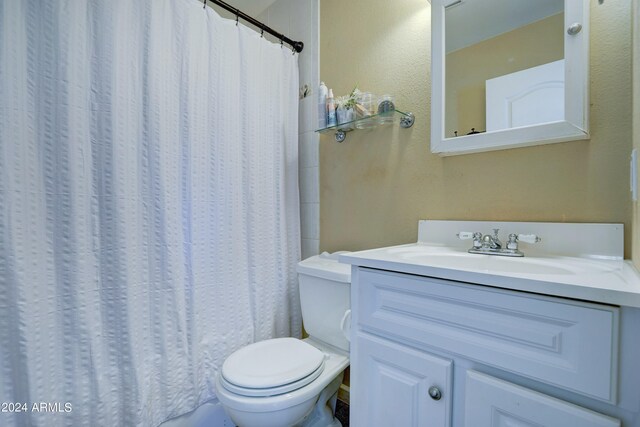 bathroom with vanity, toilet, and a shower with shower curtain