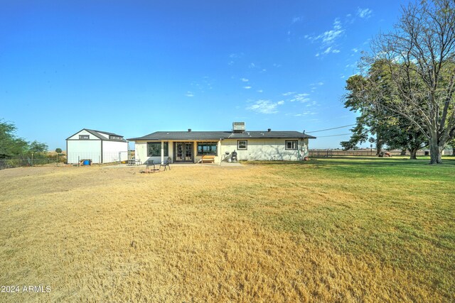 back of house with a lawn and a patio area