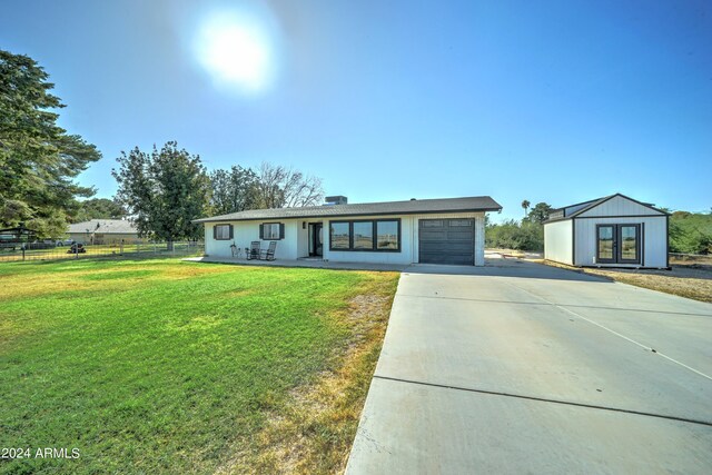 ranch-style home with a front yard and a garage