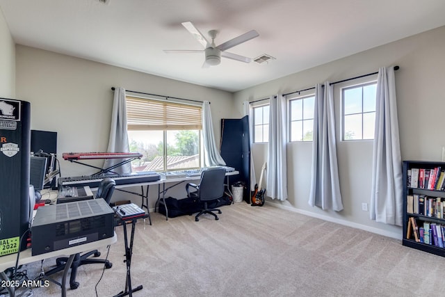 carpeted office with baseboards, a ceiling fan, and visible vents
