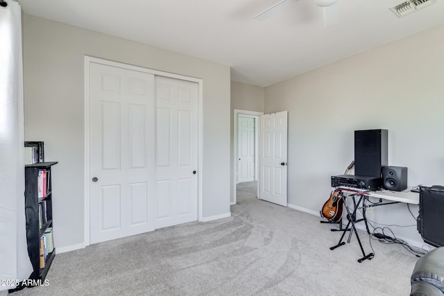 home office featuring a ceiling fan, carpet flooring, visible vents, and baseboards