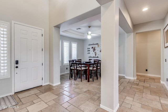 foyer entrance with a ceiling fan, baseboards, recessed lighting, and stone tile flooring