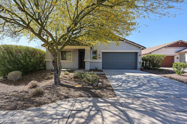 obstructed view of property with an attached garage, stucco siding, and concrete driveway