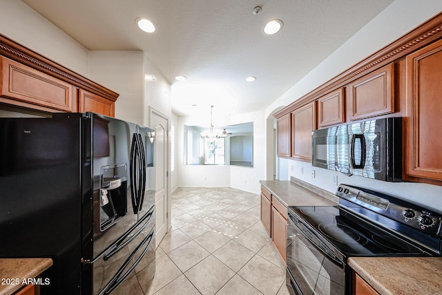 kitchen with brown cabinets, a chandelier, recessed lighting, light tile patterned floors, and black appliances