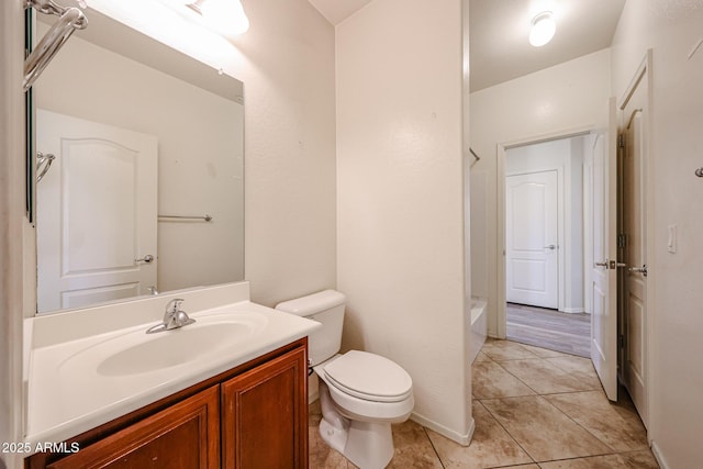 bathroom with vanity, tile patterned flooring, and toilet