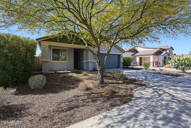 view of front of home with concrete driveway, a garage, and stucco siding