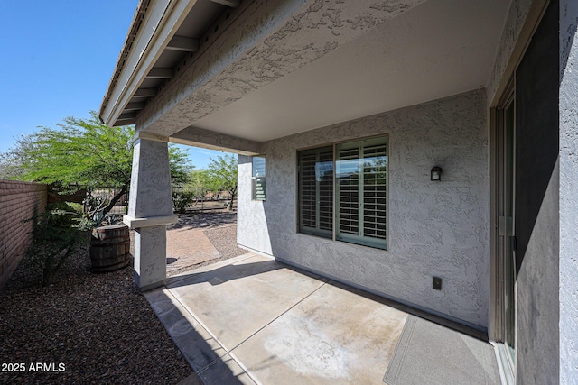 view of patio / terrace featuring fence