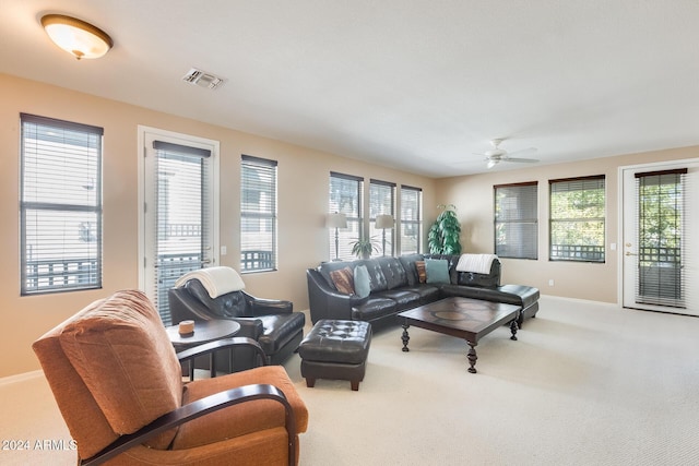 living room featuring carpet flooring and ceiling fan