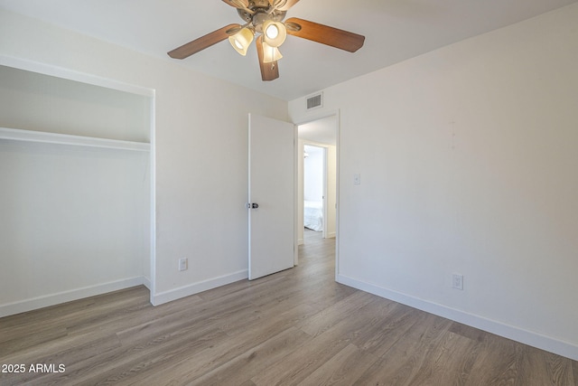 12234 S Pewaukee St, Phoenix, AZ 85044 - unfurnished bedroom featuring wood finished floors, a closet, and a ceiling fan
