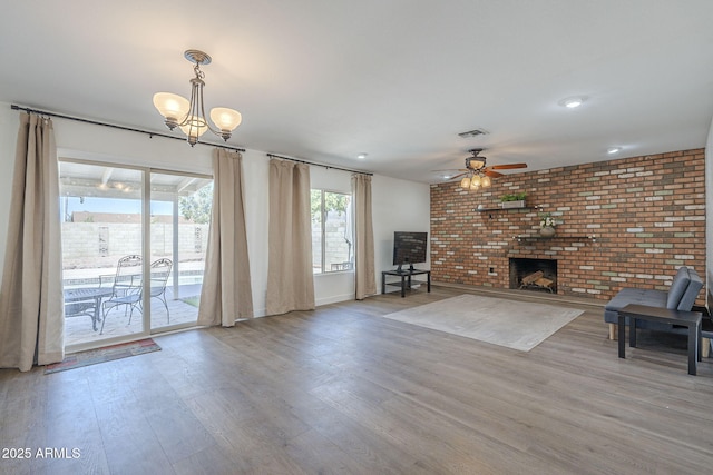 12234 S Pewaukee St, Phoenix, AZ 85044 - unfurnished living room featuring light wood-style flooring, ceiling fan, and a chandelier