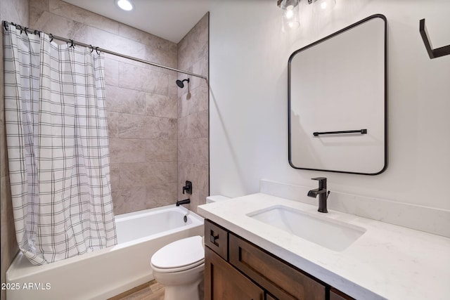 full bathroom featuring vanity, shower / bath combination with curtain, and toilet