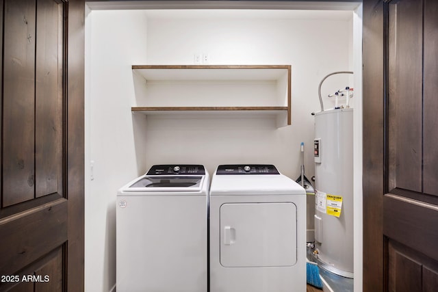 washroom with water heater, laundry area, and separate washer and dryer