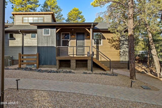 view of front of property featuring a shingled roof and a porch