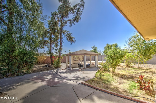 exterior space featuring a gazebo and a fenced backyard