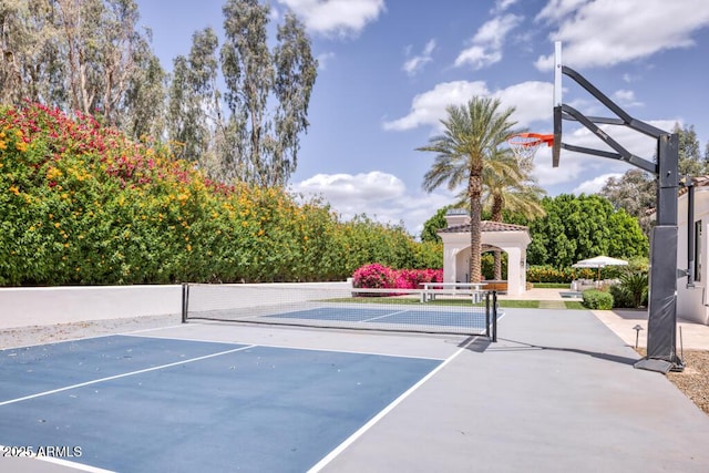 view of basketball court featuring fence and a tennis court