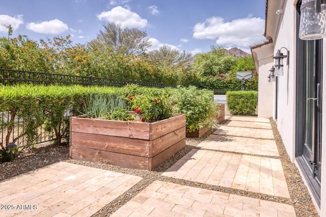 view of patio / terrace with a garden and a fenced backyard
