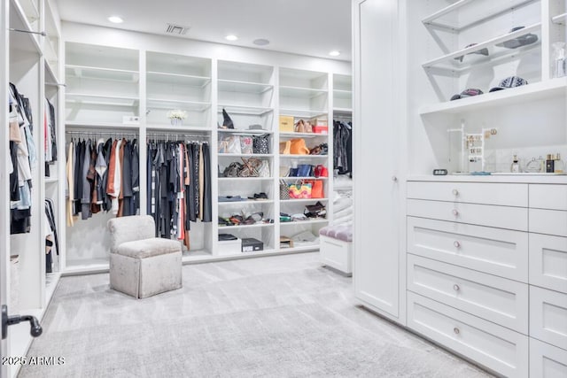 spacious closet with carpet flooring and visible vents