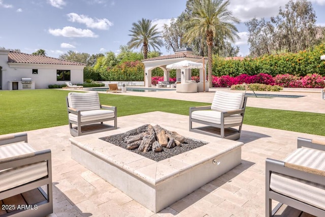 view of patio with a gazebo, a fire pit, an outdoor pool, and grilling area