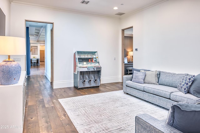 living area with crown molding, visible vents, baseboards, recessed lighting, and dark wood finished floors