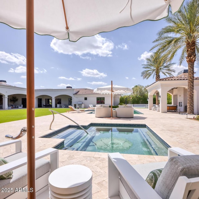 view of swimming pool with a swimming pool, an in ground hot tub, and a patio area