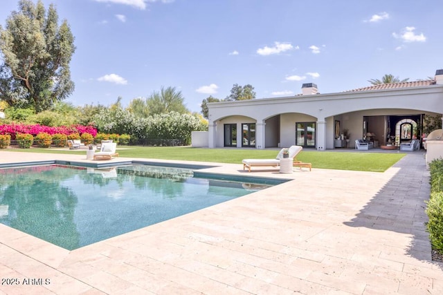 outdoor pool featuring a yard and a patio area