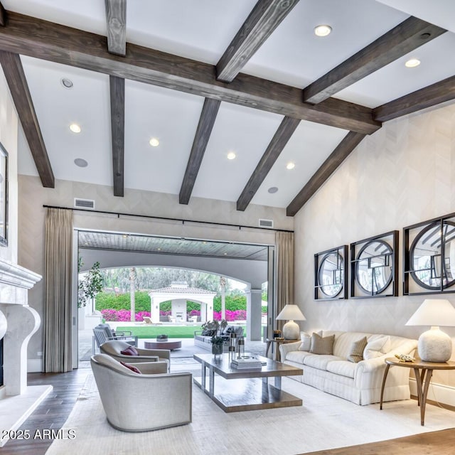 living area featuring recessed lighting, visible vents, vaulted ceiling with beams, and wood finished floors
