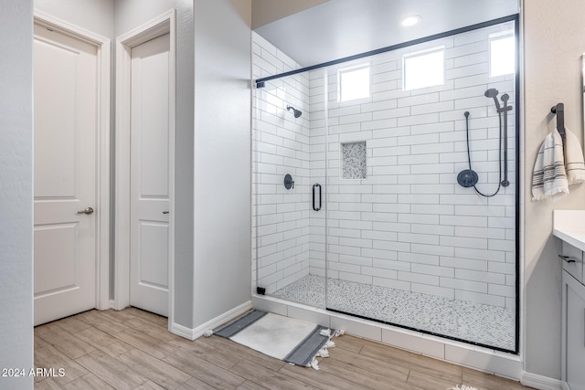 bathroom with vanity and a shower with shower door