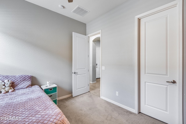 bedroom featuring light colored carpet and ceiling fan