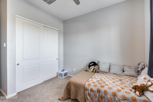 carpeted bedroom with a closet and ceiling fan