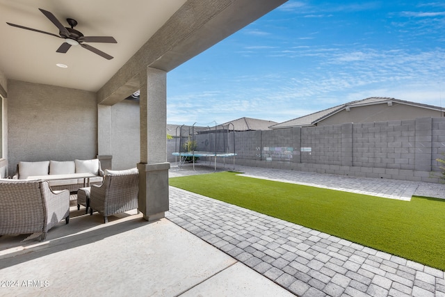 view of patio with outdoor lounge area, a trampoline, and ceiling fan