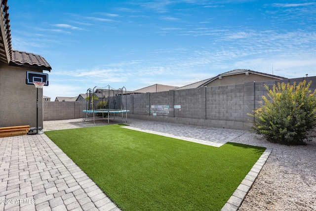 view of yard featuring a patio and a trampoline